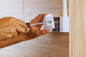 Electrician working on a power outlet or socket